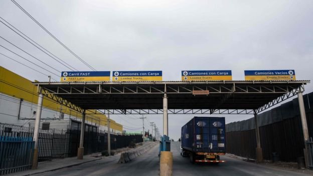 A-truck-drives-next-to-the-US-Mexico-border-fence.jpg