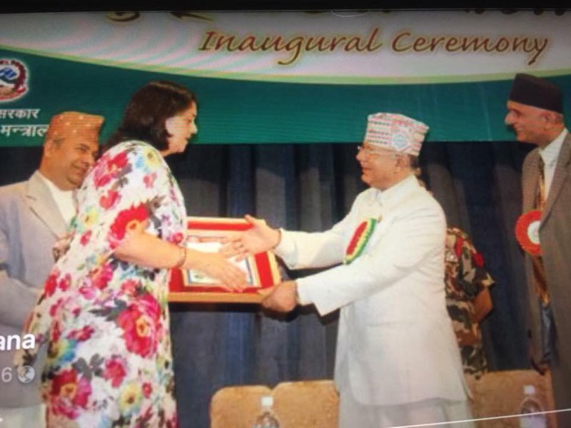 Former PM Nepal providing award.jpg