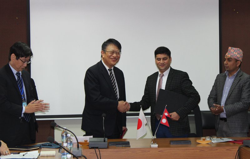 Japan ambassador to Nepal signing agreement.jpg