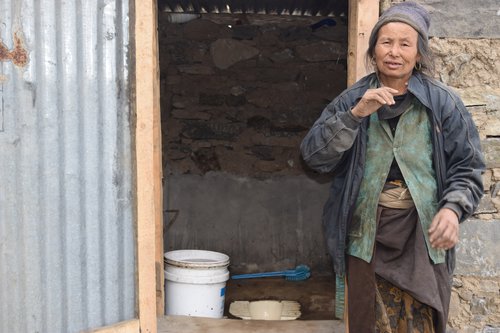 Kamisya Tamang,50, a person with disability of Grang Village of Kalika Rural Municipality -1 with recently built inclusive toilet Photo 2.JPG