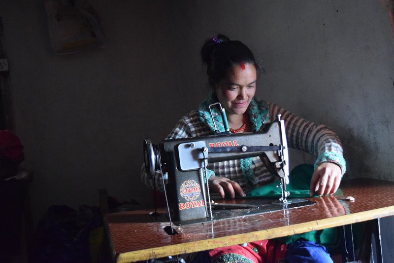 Kopila BK of Chankhu Village with her new sewing machine.jpg