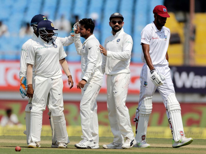 Kuldeep-Yadav-celebrates-with-his-team-mates-1st-Test.jpg