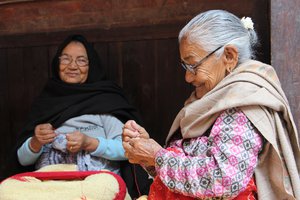 Old aged women making batti at local falcha in Pilachhen.JPG