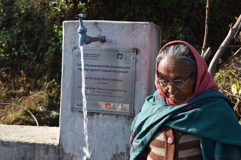 Ratna Maya BK of Suri village taking water from a tap constructed by LWF and ELCA.jpg