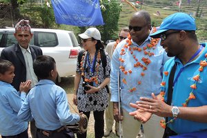 UN team being greeted by visually imparied boy playing madal in bhumiraj primary school in sunkuda village of bajhang.jpg