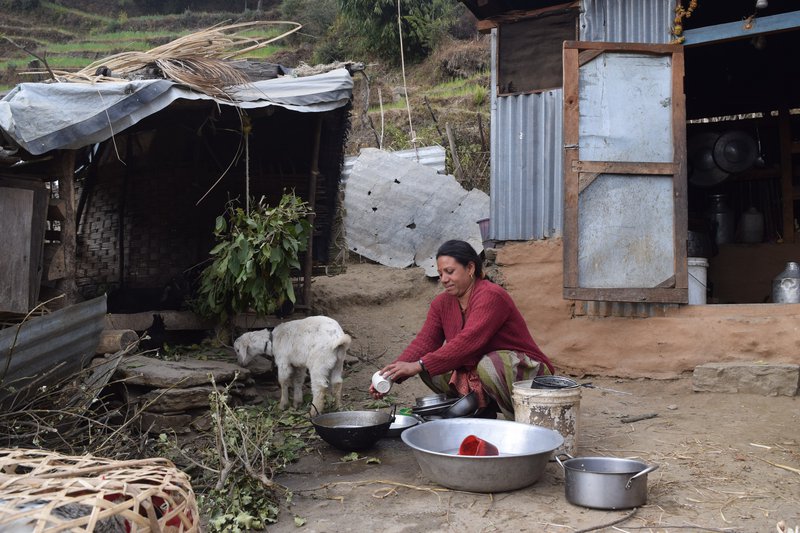 Under a WASH Support in Chankhu ward 6 of Gauri Shanker Rural Municipaity,  Kanchi Maya BK washing dishes.jpg