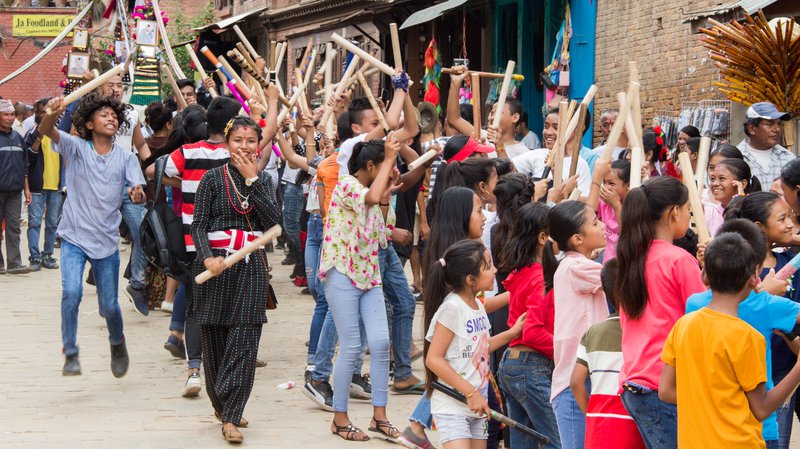 Young people clapping with wood sticks during Gai Jatra in Bhaktapur.jpg